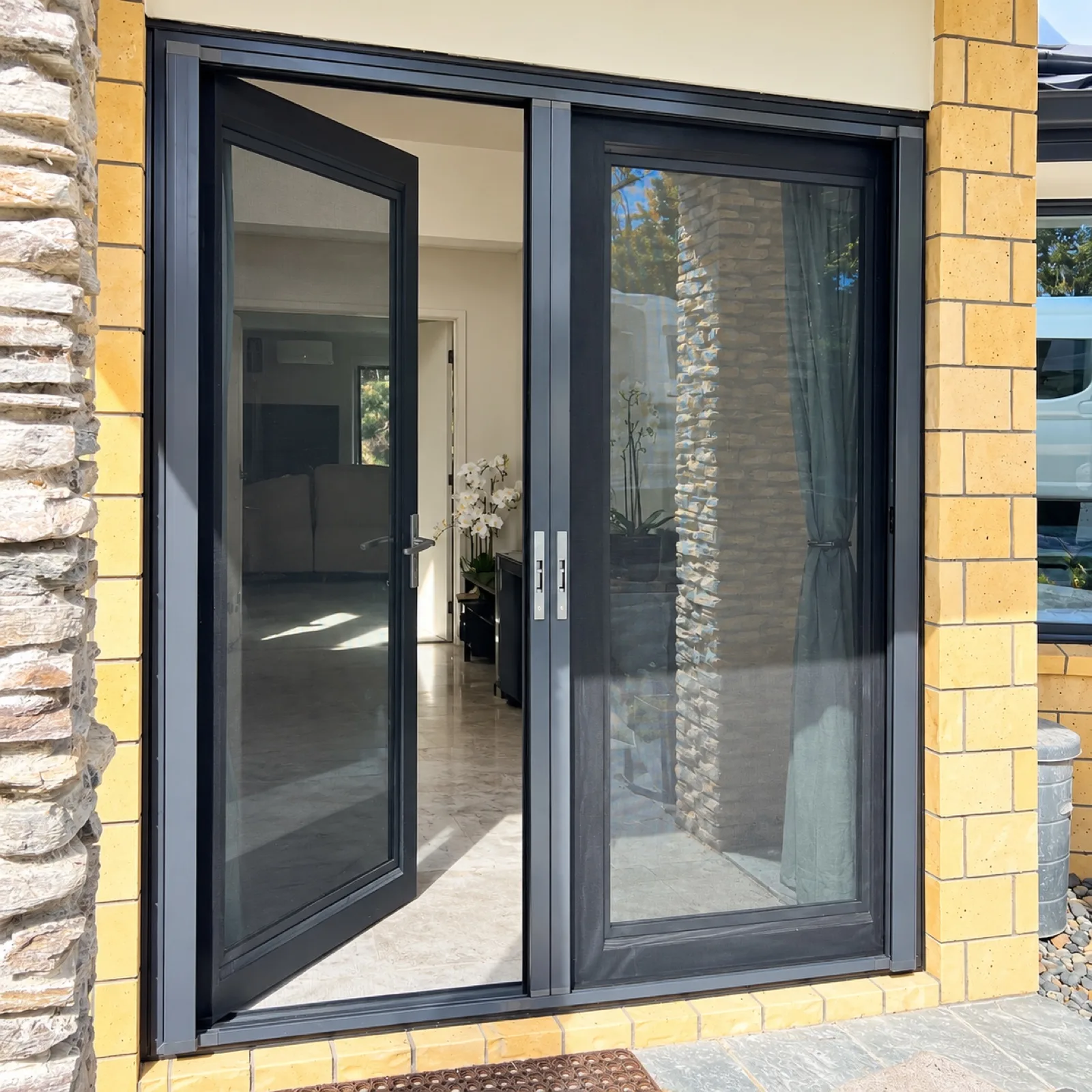 Double hinged screen doors in charcoal