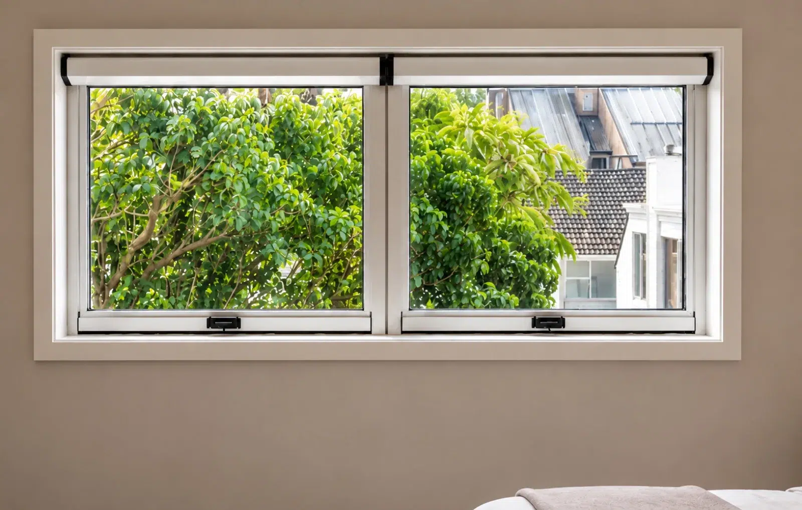 Custom-fit screens on a double window with garden view