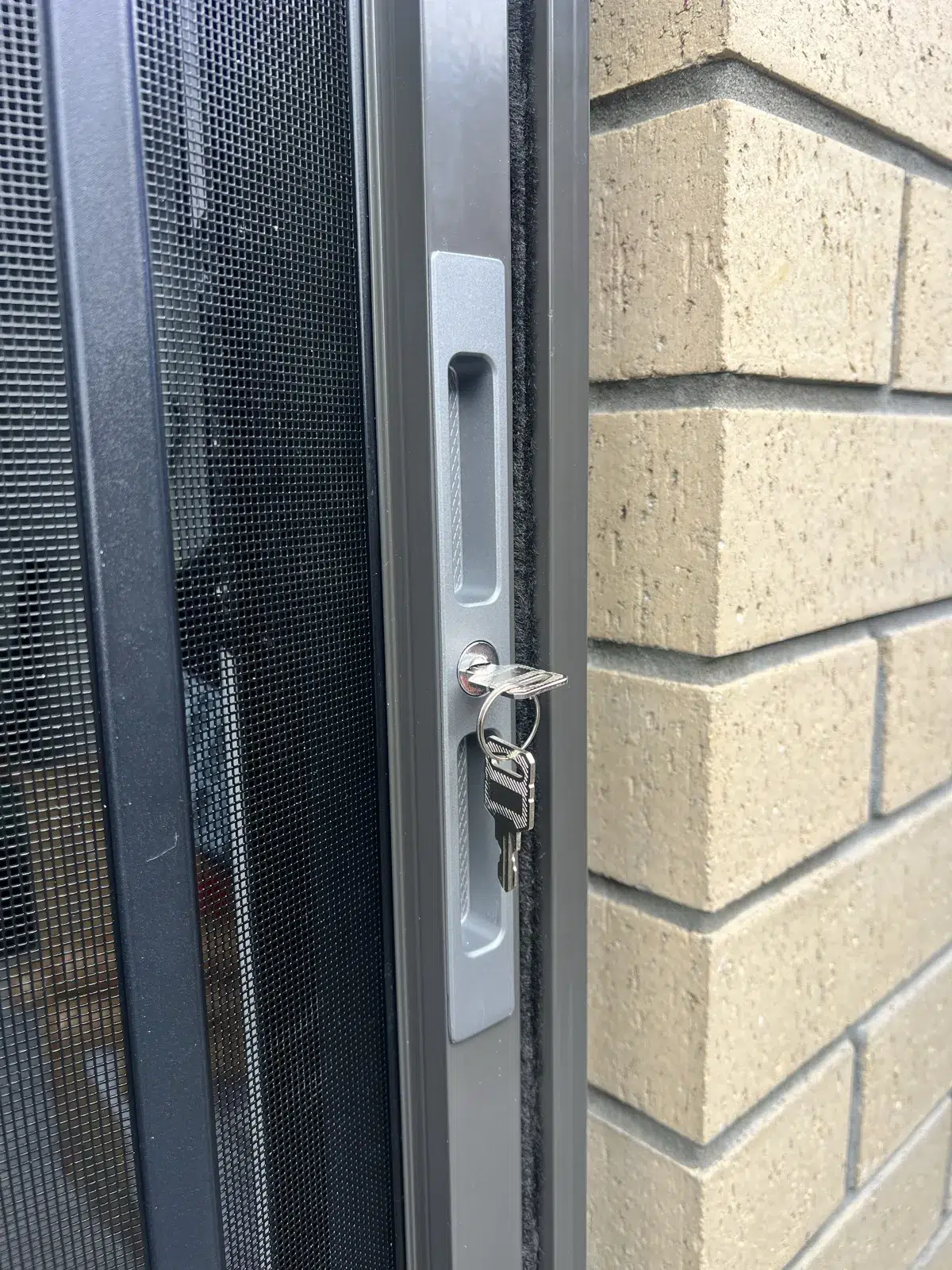 Lock and key on a pet security screen door