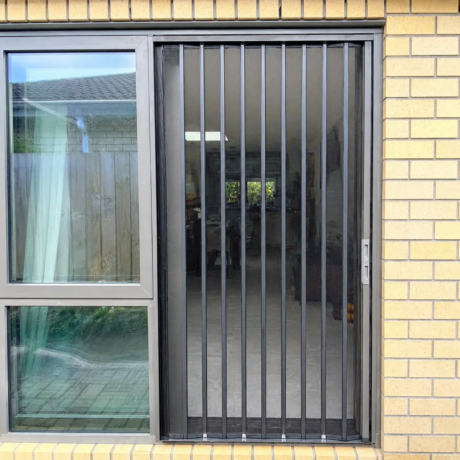 Pet-proof security screen door on a brick home