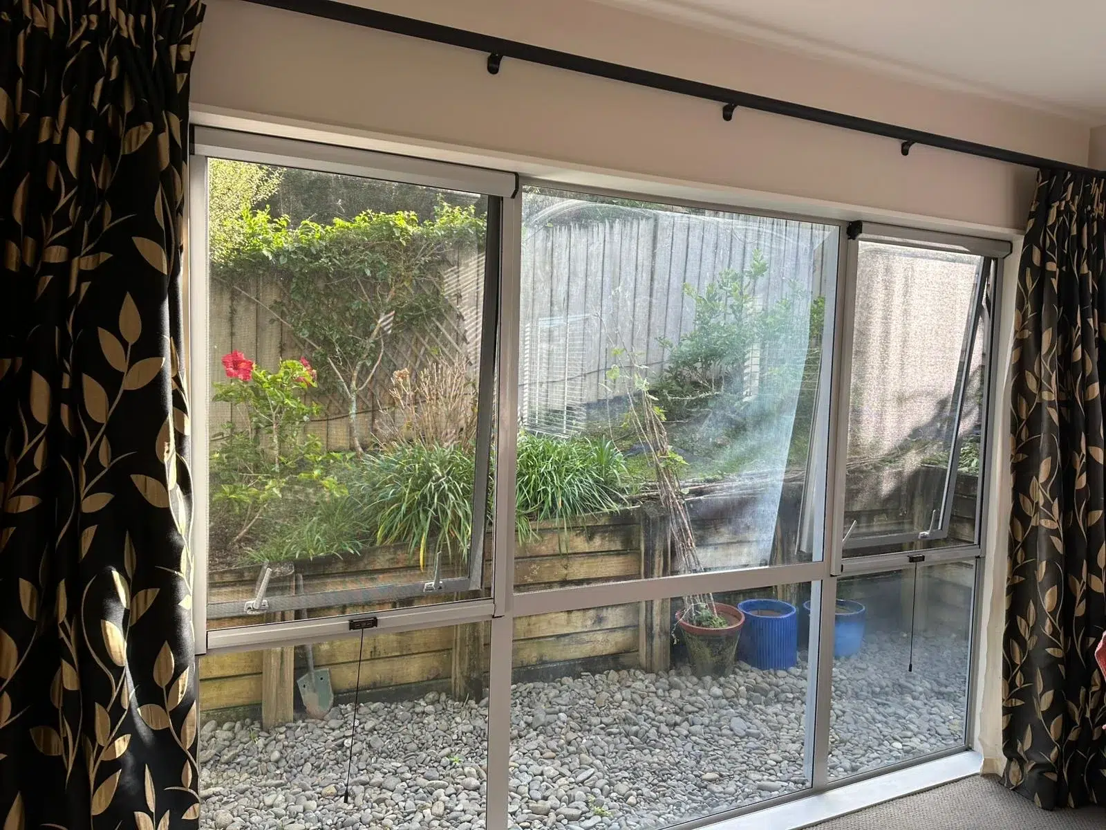 Retractable fly screens on awning windows in an Auckland home