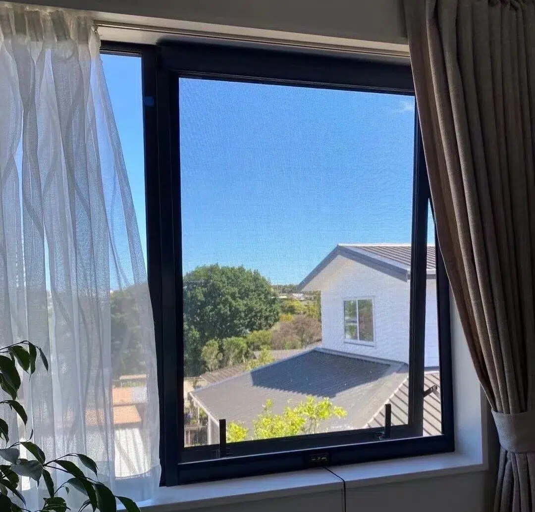 Black retractable fly screen on an awning window