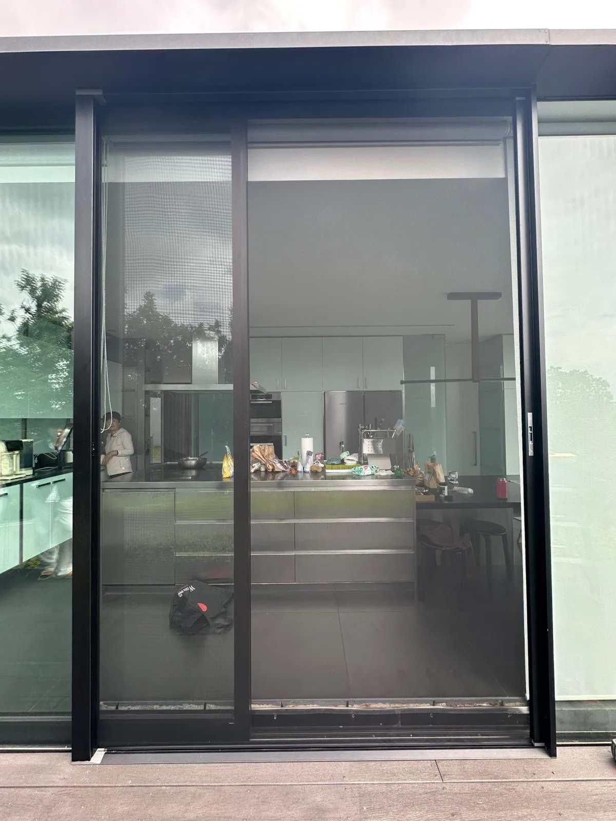 Retractable sliding door screen closed on a modern home