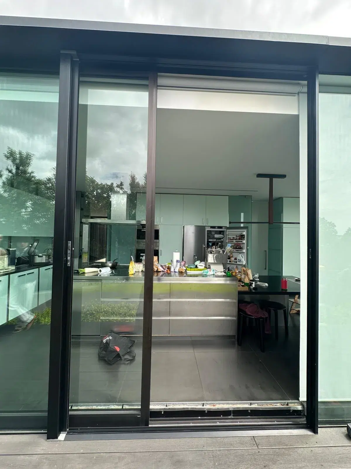 Retractable sliding door screen open on a modern home